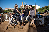 Volunteers resting after cleaning. Effects of the DANA floods of October 29, 2024, in Antonio Machado street, Paiporta, Comunidad de Valencia, Spain