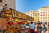 Rome, Italy, July 2017, Visitors enjoy vibrant fruits and refreshing drinks at a busy stall near Piazza di Spagna in Rome during a sunny day.