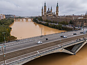 Aerial view of an abundant Ebro River passing under the Bridge after the Dana, Zaragoza, Spain