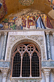 Mosaic art in a lunette on the facade of St. Mark's Basilica in Venice, Italy. This mosaic depicts the recovery of the relics of St. Mark from Egypt to Venice.