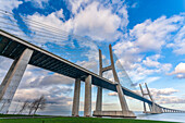 The impressive Vasco da Gama bridge stretches across the Tagus River, showcasing modern engineering and scenic views of Lisbon.