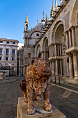 Marble lion statue on the north side of St. Mark's Basilica in Venice, Italy.