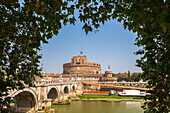 Lush trees frame Castel Sant'Angelo as it stands proudly by the Tiber River, showcasing Rome’s rich history on a clear day.