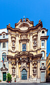 The ornate Rococo facade of Maddalena church showcases intricate sculptures and architectural details in the heart of Rome.