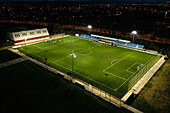 Aerial view of an illuminated amateur soccer field at night