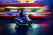 Rome, Italy, July 22 2017, A scooter zips through the vibrant streets of Rome, capturing the essence of Italian city life at dusk.