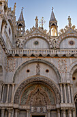 Elaborate Moorish arch over the entrance on the north facade of St. Mark's Basilica in Venice, Italy.