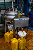 The olive oil passes through a final filter to remove further impurities in an olive oil mill in Italy.