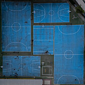 Aerial view of blue basketball and sports courts in school playground