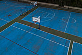 Aerial view of blue basketball and sports courts in school playground