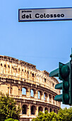 Colosseum with street sign and traffic light in Rome's historic center.