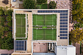 Aerial view of paddle tennis courts and solar panels