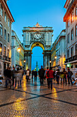 Lisbon, Portugal, March 1 2007, Pedestrians wander through the Augusta street triumphal arch at dusk, leading to the vibrant Praça do Comércio in Lisbon.