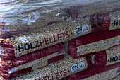 Pellet stove fuel pellets made from dried and ground olive pits after olive processing in an olive oil mill in Italy.