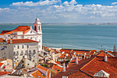 Discover the stunning panoramic view of Lisbon from Santa Luzia, featuring the distinctive Santo Estevao church and the Tagus River.