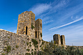 Watchtowers on the city wall of the medieval walled town of Monteriggioni, Sienna, Tuscany, Italy. View from inside the walls.