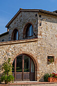 Traditional architecture of a farmhouse on a lavender farm in Sienna Province, Italy.