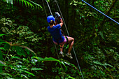 Young caucasian woman canyoning and rappelling in Costa Rica