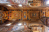 Rome, Italy, July 22 2017, The intricately decorated ceiling of the crossing showcases rich details and vibrant colors in San Giovanni in Laterano, Rome, Italy.