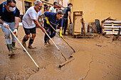 People cleaning. Effects of the DANA floods of October 29, 2024, Pelayo street, Paiporta, Comunidad de Valencia, Spain