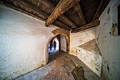 Ancient archway in Santa Cruz Quarter, Sevilla, showing historical architecture.