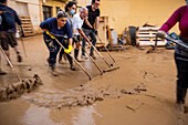 People cleaning. Effects of the DANA floods of October 29, 2024, Pelayo street, Paiporta, Comunidad de Valencia, Spain