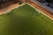 Aerial view of a training in a soccer field at night