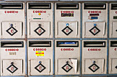 A row of vintage mailboxes in Bairro Alto, Lisbon, reflecting the city's unique urban architecture and history.