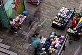 Street vendors near a metro station in Medellin, Colombia. The metro includes street level trains and even aerial cable cars to connectthe city's downtown to the poorer neighborhoods in the surrounding mountains.