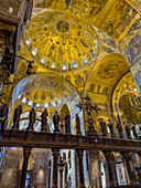 A Gothic altar screen encloses the chancel in St. Mark's Basilica in Venice, Italy with a crucifix & statues.