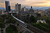 View of Plaza Botero and the famous metro system Medellin, Colombia. The metro includes street level trains and even aerial cable cars to connectthe city's downtown to the poorer neighborhoods in the surrounding mountains.