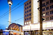 Berlin, Germany, July 29 2009, Explore the illuminated Alexanderplatz at night, featuring the iconic Fernsehturm tower and bustling urban architecture in Berlin.