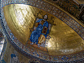 A gold mosaic of Christ on a throne in the cupola of the main apse in St. Mark's Basilica, Venice, Italy.