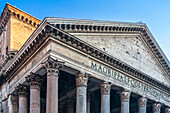 Exploring the magnificent architecture of the Pantheon in Rome, Italy, showcasing its grand columns and ancient design under a blue sky.