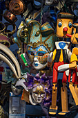 Pinocchio marionettes and carnival masks for sale in a souvenir shop in Venice, Italy.