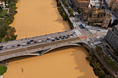 Aerial view of an abundant Ebro River passing under the Bridge after the Dana, Zaragoza, Spain