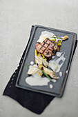 Grilled veal tongue with winter radish and apple and leek