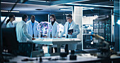 Neuroscientists having meeting around brain hologram