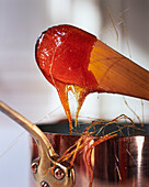 Melted caramel with strings in a copper pot