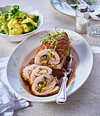 Pork roulade with apple and nut filling and herbs