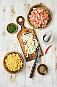 Ingredients for pasta dish with bacon and onions
