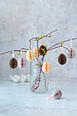 Easter eggs made from folded paper on twigs