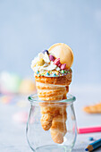 Puff pastry school cone with cream and sweets