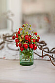 Wild strawberries in a glass of water