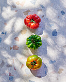 Three pineapple tomatoes on a stone plate