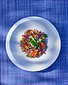 Quinoa salad with cherry tomatoes, coriander and red onions