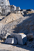 A Carrara marble bench for sitting on during the quarry tour in Fantiscritti. Carrara, Italy. A quarry is behind.