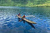 Residents of Vitu Islands in their traditional dugout canoes, Garove Island, Johann Albrecht Harbour, Papua New Guinea