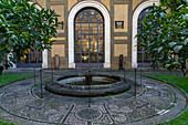 Mosaic designs in the walkway around a fountain in the gardens of the Palazzo Medici Riccardi. Florence, Italy.