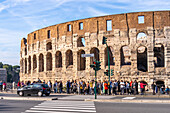 The Via Celio Vibenna and tourists at the ancient Roman Colosseum in Rome, Italy.